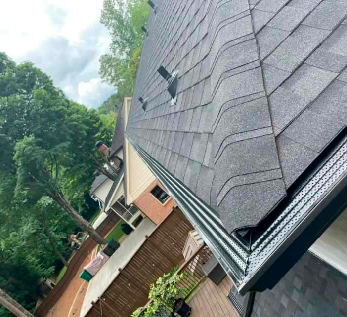 gutter installation with a dark grey roofing